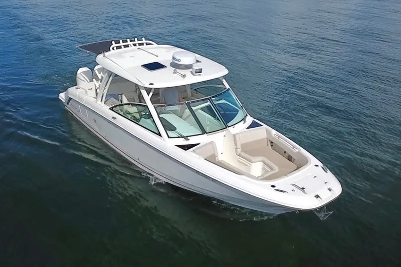 Slide: The Image of 2021 Boston Whaler 320 Vantage boat cruising on calm blue waters. - 9