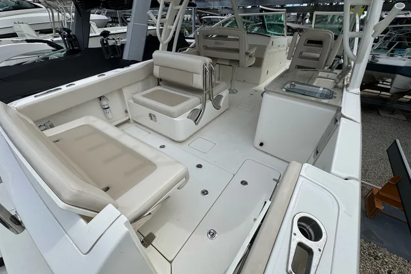 Slide: The Image of 2021 Boston Whaler 320 Vantage boat interior with beige seating and modern amenities. - 30