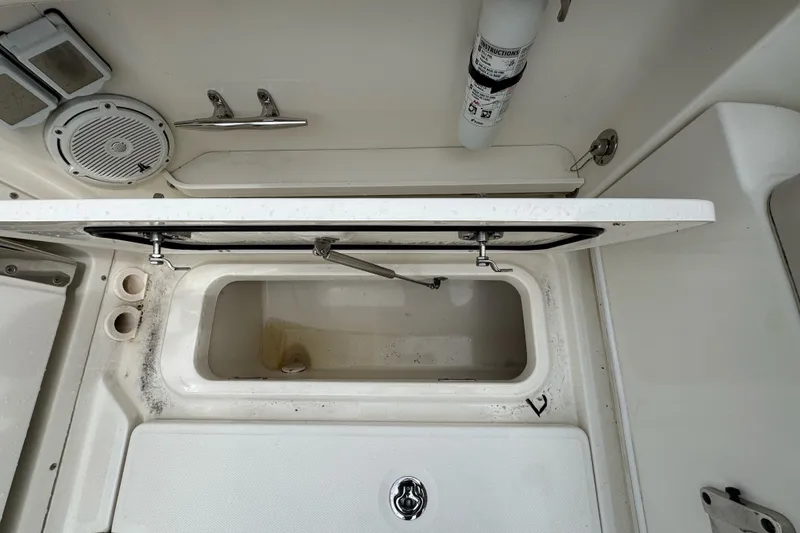 Slide: The Image of Open storage compartment on a 2021 Boston Whaler 320 Vantage boat deck. - 35