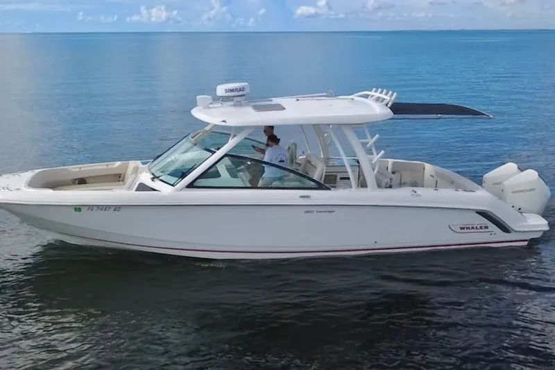 Slide: The Image of 2021 Boston Whaler 320 Vantage boat cruising on calm blue waters. - 6