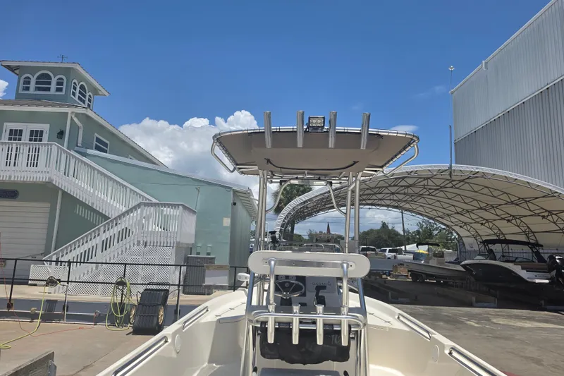 Slide: The Image of 2021 Bulls Bay 2200 boat docked near a marina with blue sky background. - 21