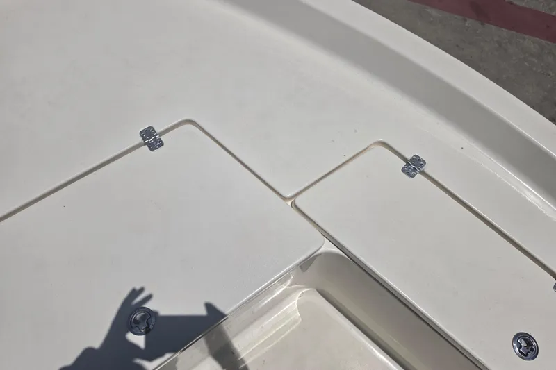Slide: The Image of 2021 Bulls Bay 2200 boat deck with storage compartments and metal hinges. - 61