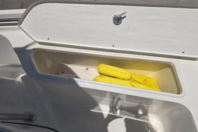 Slide: The Image of 2021 Bulls Bay 2200 boat interior with yellow gloves in storage compartment. - 67
