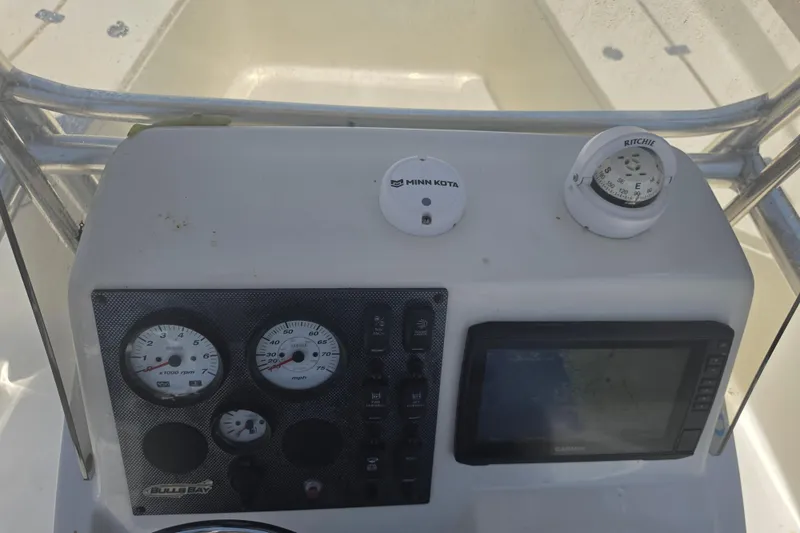 Slide: The Image of 2021 Bulls Bay 2200 boat dashboard with gauges, compass, and Garmin display. - 39