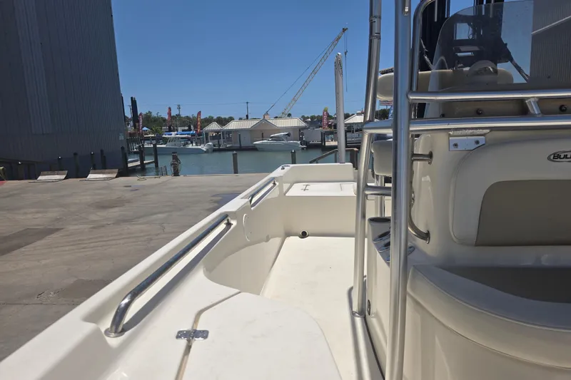 Slide: The Image of 2021 Bulls Bay 2200 boat docked at marina, showcasing sleek design and spacious deck. - 72