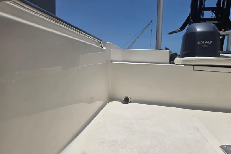 Slide: The Image of 2021 Bulls Bay 2200 boat interior with Yamaha 200 engine, under clear blue sky. - 75