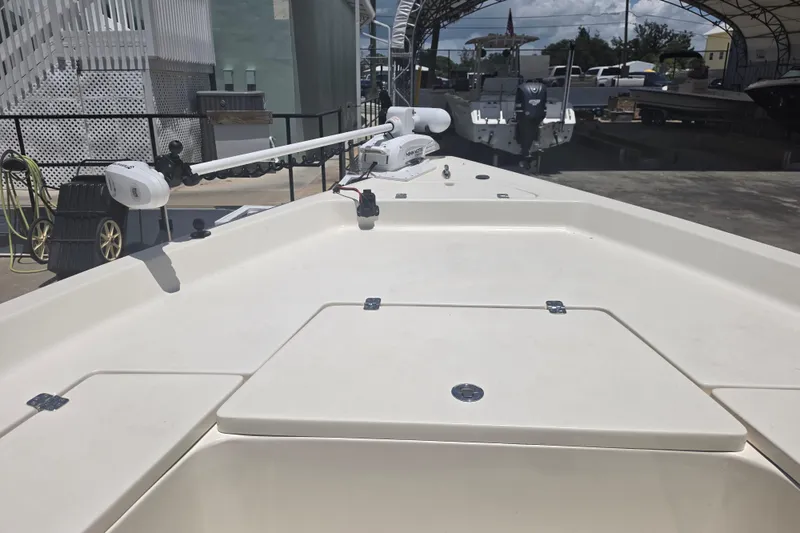 Slide: The Image of 2021 Bulls Bay 2200 boat deck with trolling motor in a marina setting. - 53
