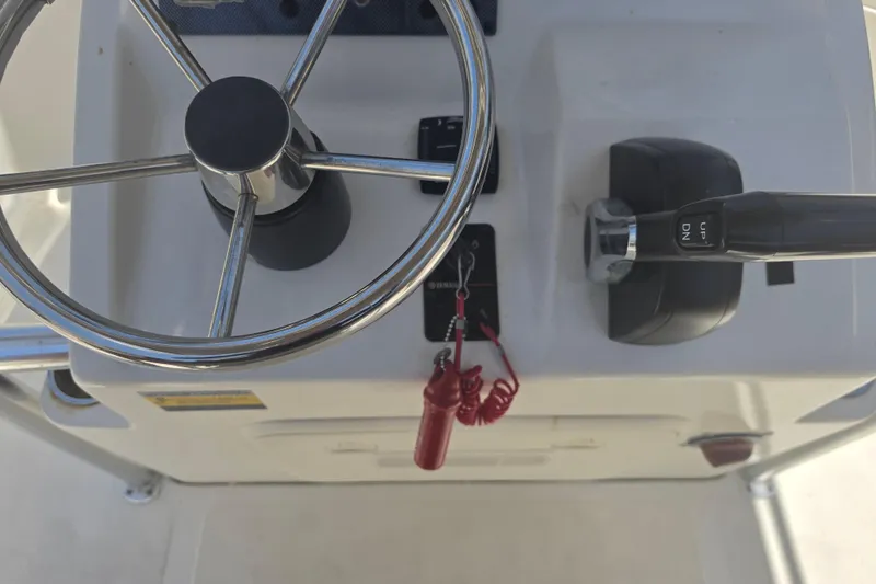Slide: The Image of 2021 Bulls Bay 2200 boat console with steering wheel and throttle controls. - 34