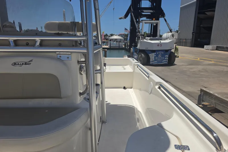 Slide: The Image of 2021 Bulls Bay 2200 boat docked at a marina with industrial equipment nearby. - 71