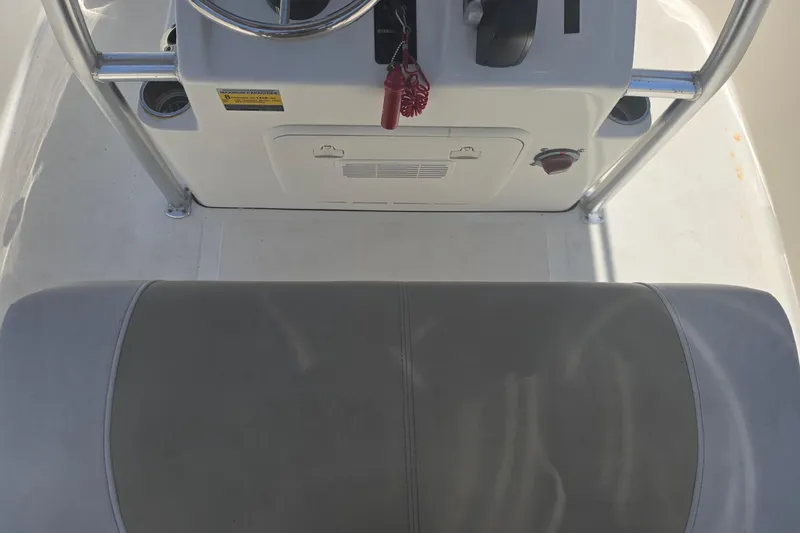 Slide: The Image of 2021 Bulls Bay 2200 boat console with steering wheel and cushioned seat. - 47