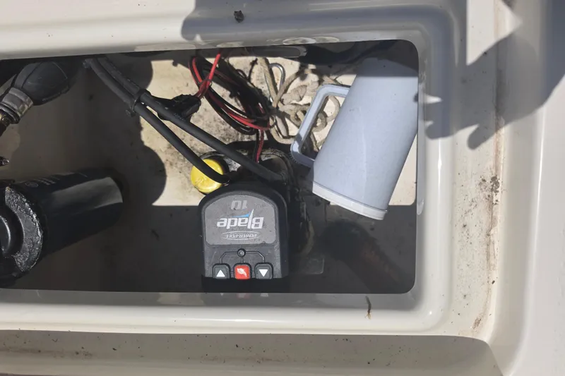 Slide: The Image of Electrical compartment of a 2021 Bulls Bay 2200 boat with wiring and a Power-Pole control unit. - 83