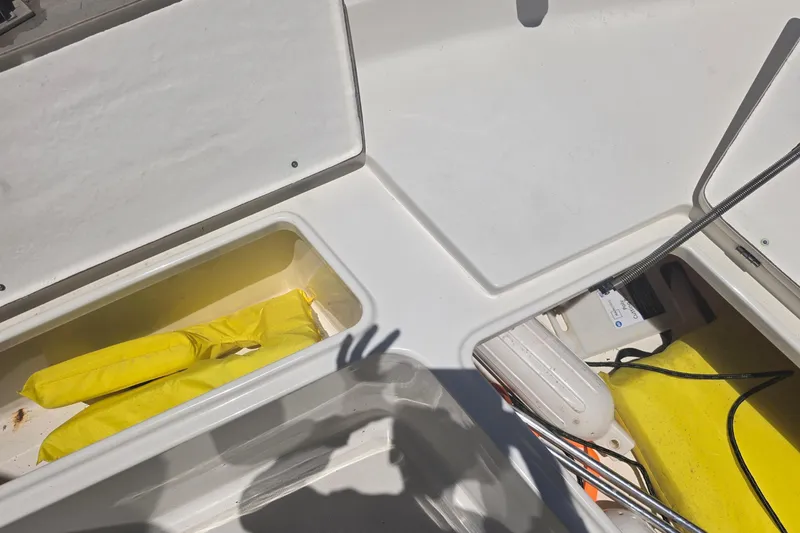 Slide: The Image of 2021 Bulls Bay 2200 boat interior with storage compartments and yellow life jackets. - 66