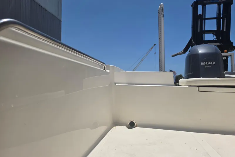 Slide: The Image of 2021 Bulls Bay 2200 boat with Yamaha 200 engine, docked under clear blue sky. - 74