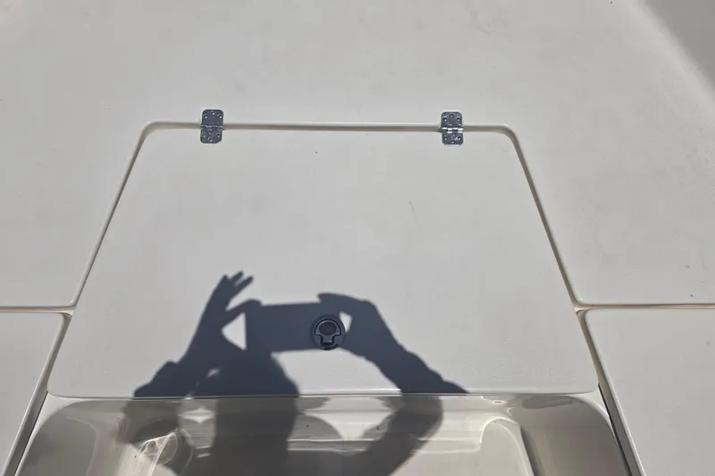 Slide: The Image of Shadow on Bulls Bay 2200 boat deck, 2021 model, with hatch and hinges visible. - 58