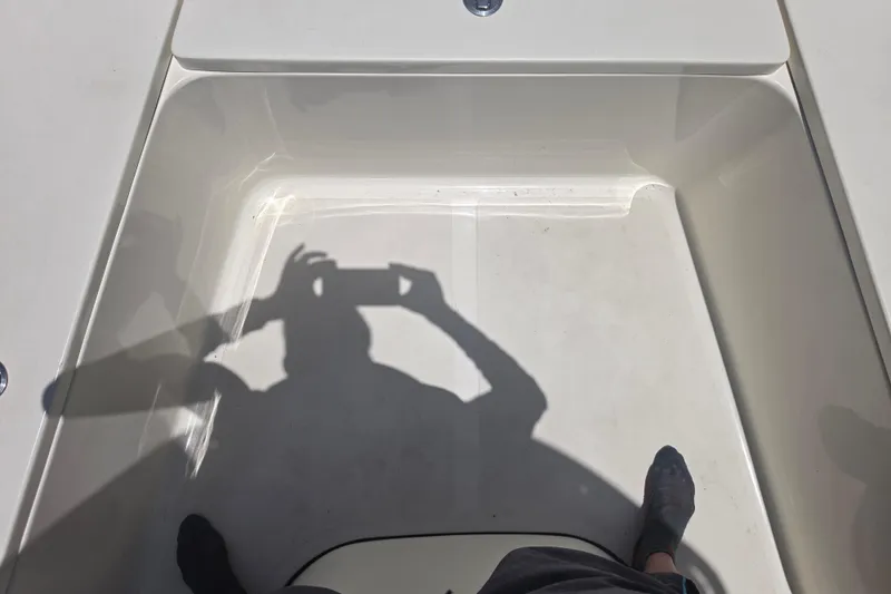 Slide: The Image of Shadow of a person taking a photo inside a 2021 Bulls Bay 2200 boat. - 55