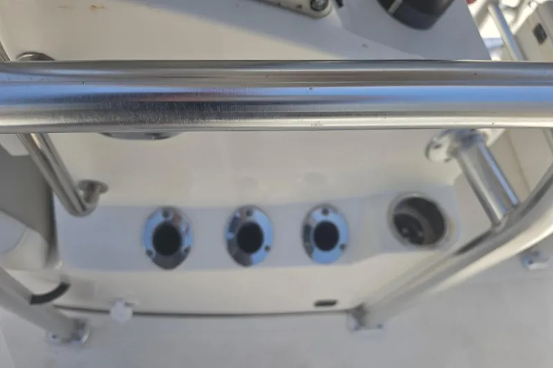 Slide: The Image of Close-up of a 2021 Bulls Bay 2200 boat's stainless steel rod holders and railing. - 78