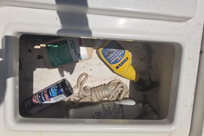 Slide: The Image of Boat storage compartment with cleaning supplies and rope on a 2021 Bulls Bay 2200. - 85