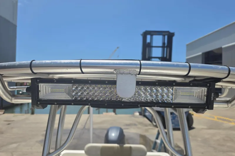 Slide: The Image of 2021 Bulls Bay 2200 boat with mounted LED light bar on T-top, dockside view. - 62