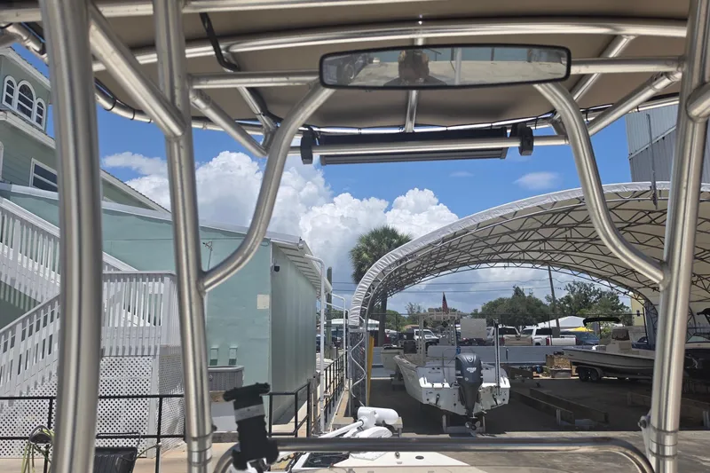 Slide: The Image of 2021 Bulls Bay 2200 boat under canopy with clear blue sky background. - 48