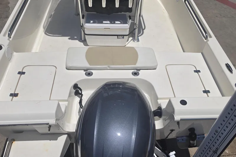 Slide: The Image of 2021 Bulls Bay 2200 boat interior with motor, featuring spacious seating and storage. - 20