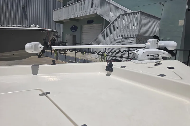 Slide: The Image of 2021 Bulls Bay 2200 boat with Minn Kota Terrova trolling motor in a marina setting. - 19