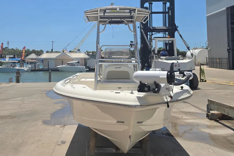 Slide: The Image of 2021 Bulls Bay 2200 boat docked at a marina under clear blue skies. - 15