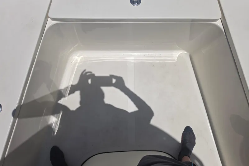 Slide: The Image of Shadow on Bulls Bay 2200 boat deck, 2021 model, with person taking a photo. - 56