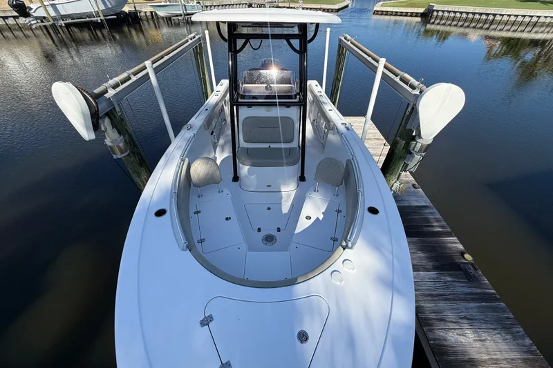 Slide: The Image of 2023 Sportsman Heritage 241 Center Console boat docked on calm water. - 40