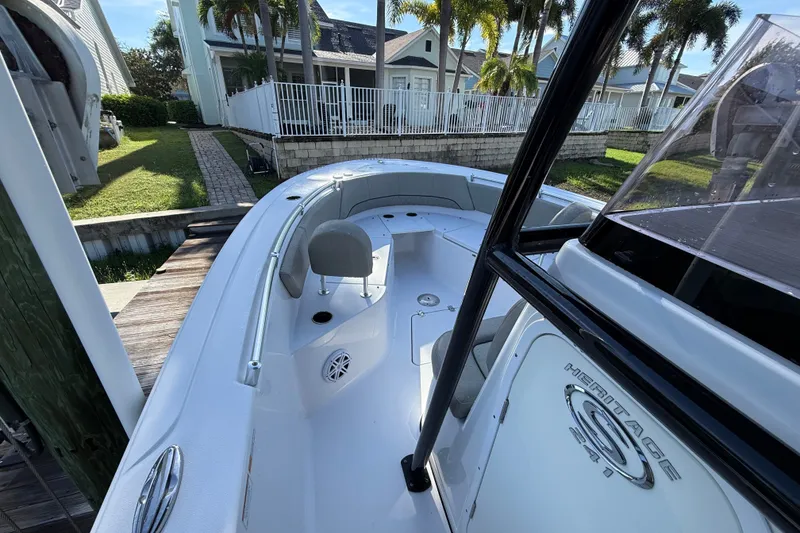 Slide: The Image of 2023 Sportsman Heritage 241 Center Console boat docked near waterfront homes. - 28