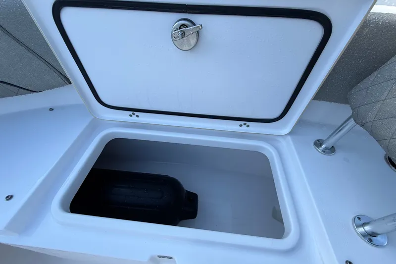Slide: The Image of 2023 Sportsman Heritage 241 Center Console storage compartment with open hatch. - 34