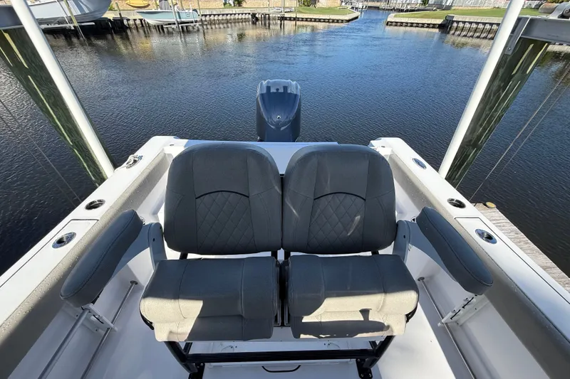 Slide: The Image of 2023 Sportsman Heritage 241 Center Console boat seats overlooking marina. - 53