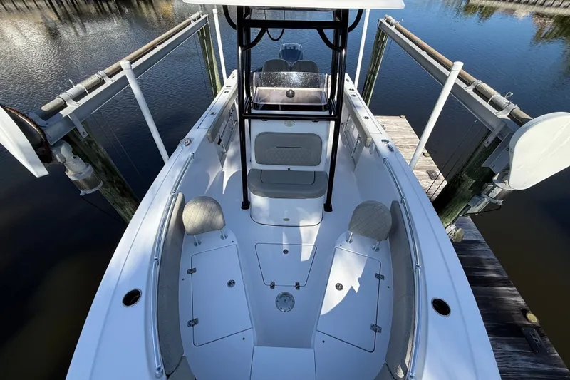 Slide: The Image of 2023 Sportsman Heritage 241 Center Console boat docked on calm water. - 42