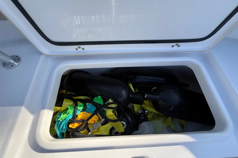 Slide: The Image of Storage compartment on 2023 Sportsman Heritage 241 Center Console with boating gear. - 32