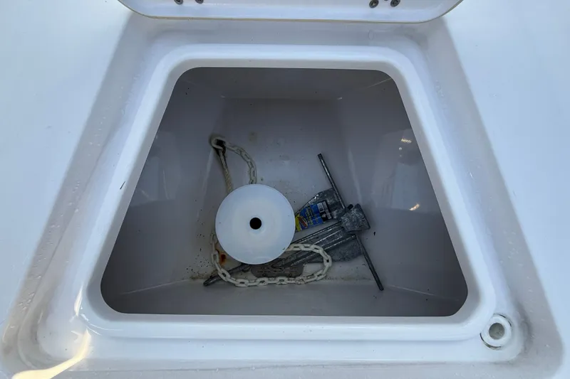 Slide: The Image of Anchor storage compartment on 2023 Sportsman Heritage 241 Center Console boat. - 33