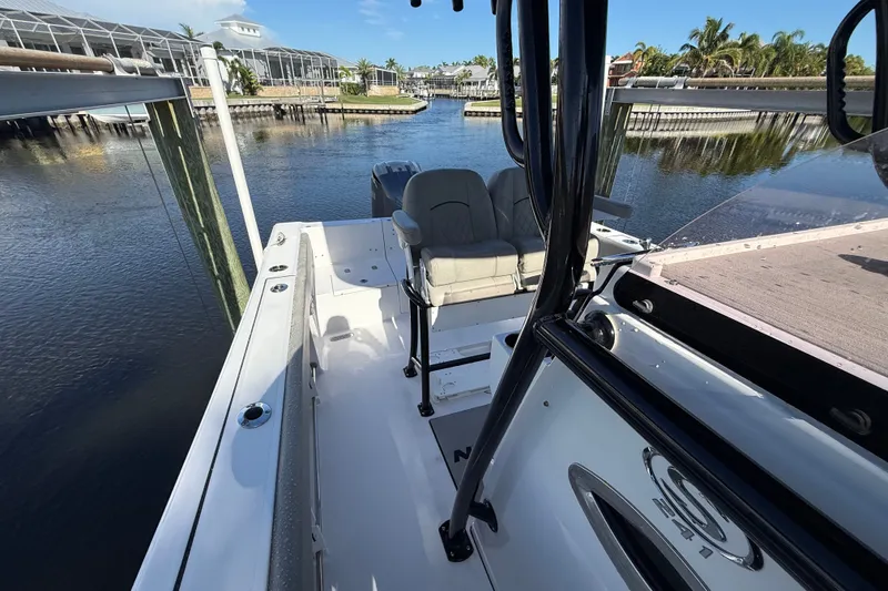Slide: The Image of 2023 Sportsman Heritage 241 Center Console boat docked in a scenic marina. - 51