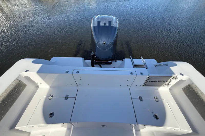 Slide: The Image of 2023 Sportsman Heritage 241 Center Console boat stern view with outboard motor. - 60