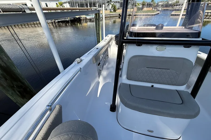 Slide: The Image of 2023 Sportsman Heritage 241 Center Console boat docked by waterfront. - 49