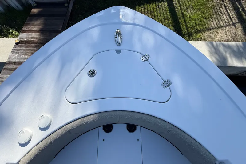 Slide: The Image of 2023 Sportsman Heritage 241 Center Console boat deck with storage hatch. - 38