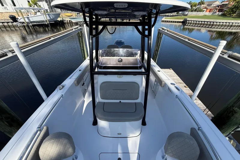 Slide: The Image of 2023 Sportsman Heritage 241 Center Console boat docked in a serene marina. - 44