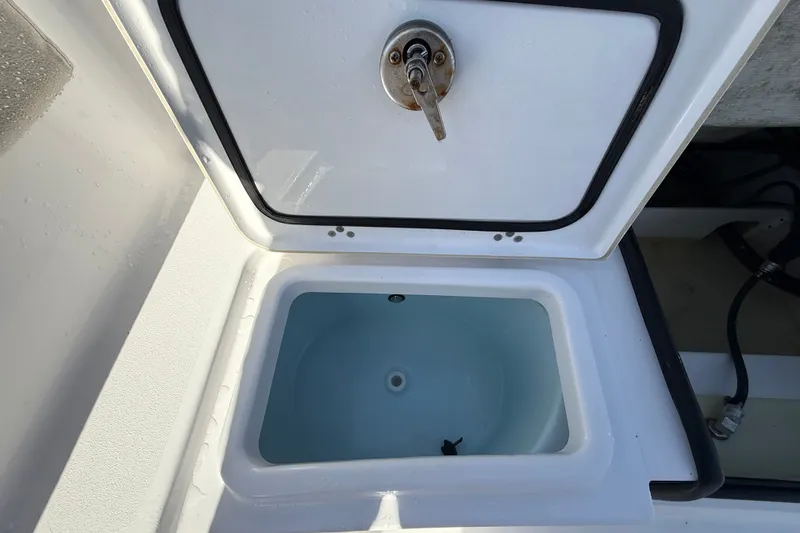 Slide: The Image of Open storage compartment on 2023 Sportsman Heritage 241 Center Console boat. - 57
