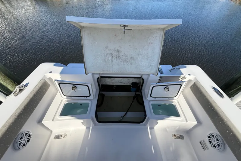 Slide: The Image of 2023 Sportsman Heritage 241 Center Console boat with open storage compartments. - 56