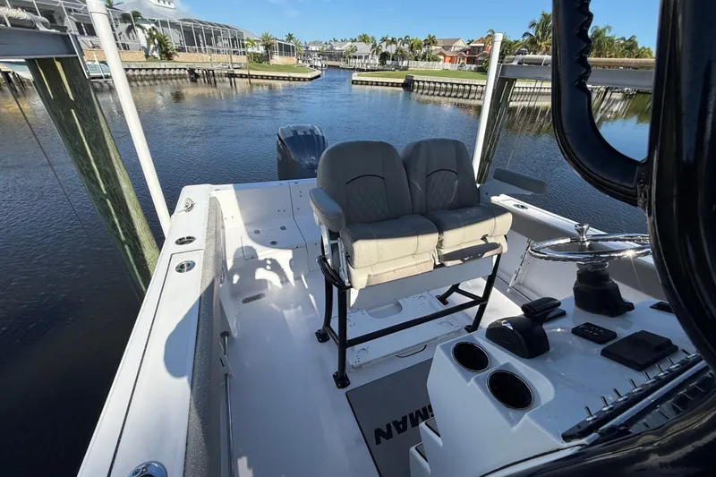 Slide: The Image of 2023 Sportsman Heritage 241 Center Console boat docked in a scenic waterfront location. - 52