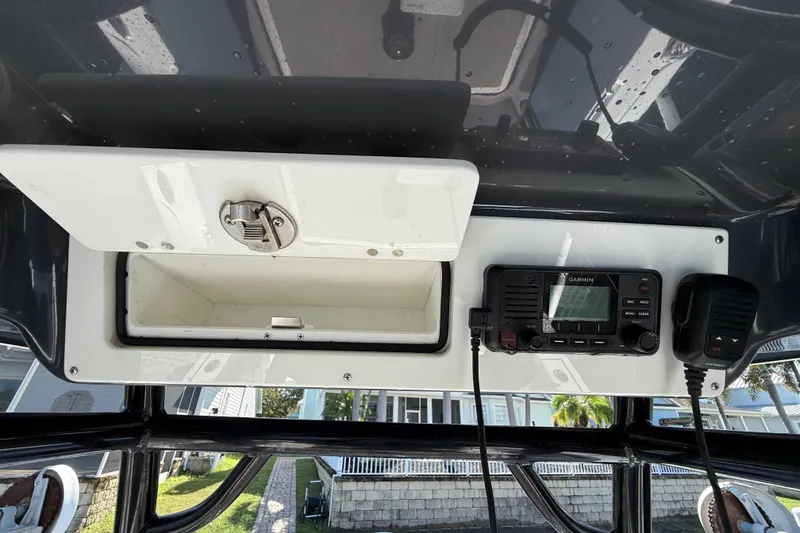 Slide: The Image of 2023 Sportsman Heritage 241 Center Console dashboard with storage and Garmin radio. - 23