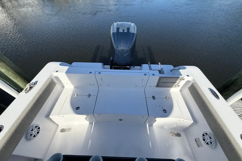 Slide: The Image of 2023 Sportsman Heritage 241 Center Console boat, rear view with motor on calm water. - 55