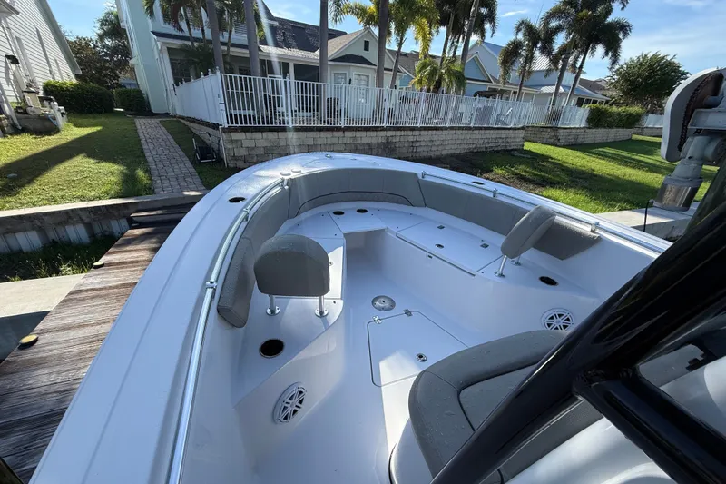 Slide: The Image of 2023 Sportsman Heritage 241 Center Console boat docked near waterfront homes. - 29