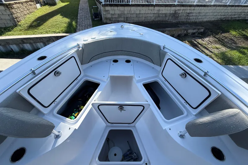 Slide: The Image of 2023 Sportsman Heritage 241 Center Console boat with open storage compartments and seating. - 31