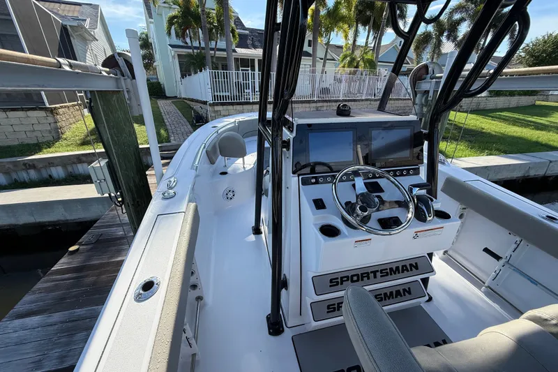 Slide: The Image of 2023 Sportsman Heritage 241 Center Console boat interior with steering wheel and controls. - 25