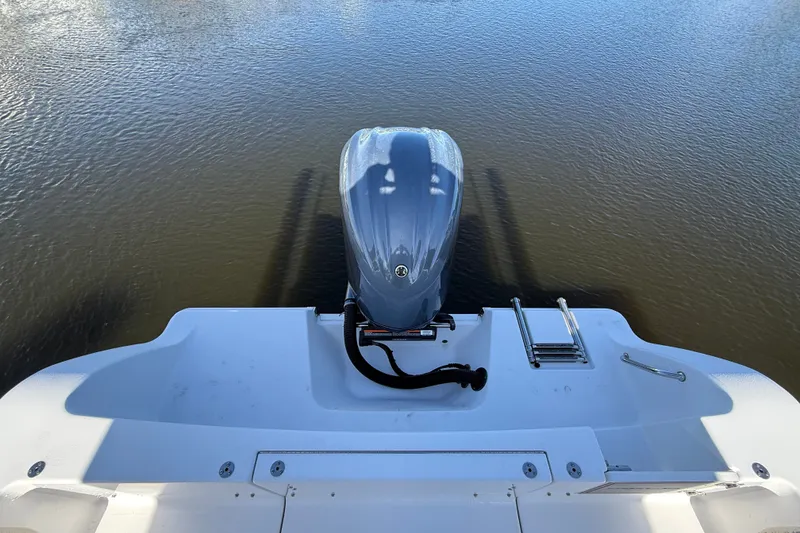 Slide: The Image of 2023 Sportsman Heritage 241 Center Console boat with outboard motor on calm water. - 61