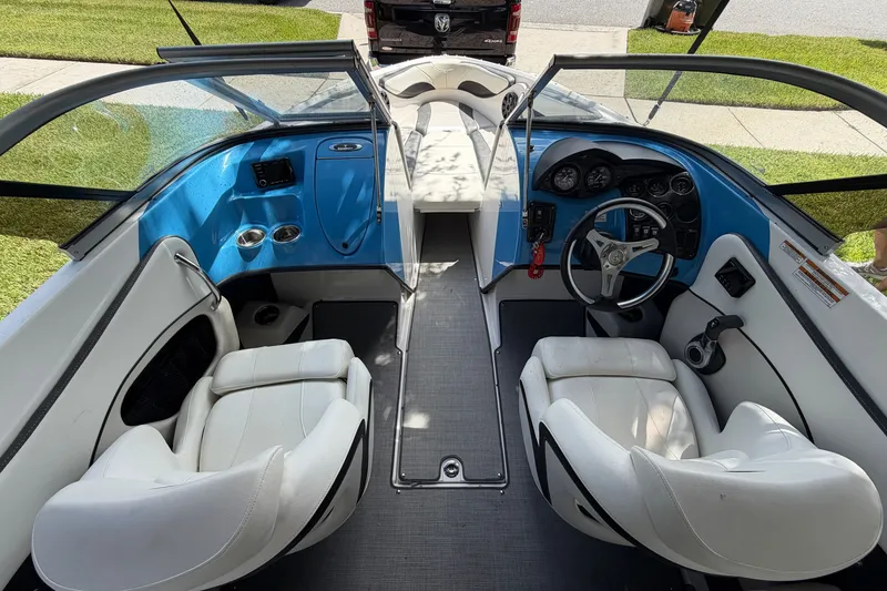 Slide: The Image of Interior of 2021 Campion Allante 180 boat with white seats and blue dashboard. - 13
