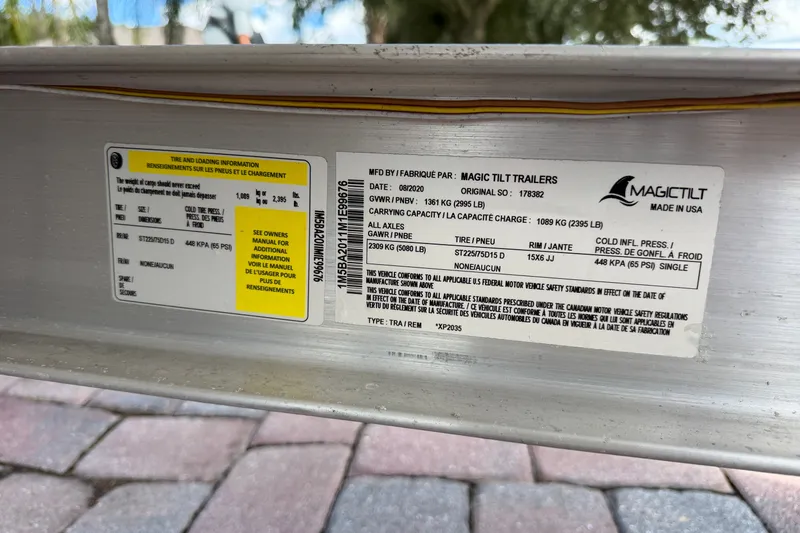 Slide: The Image of Sticker on Magic Tilt trailer showing tire and loading information. - 40